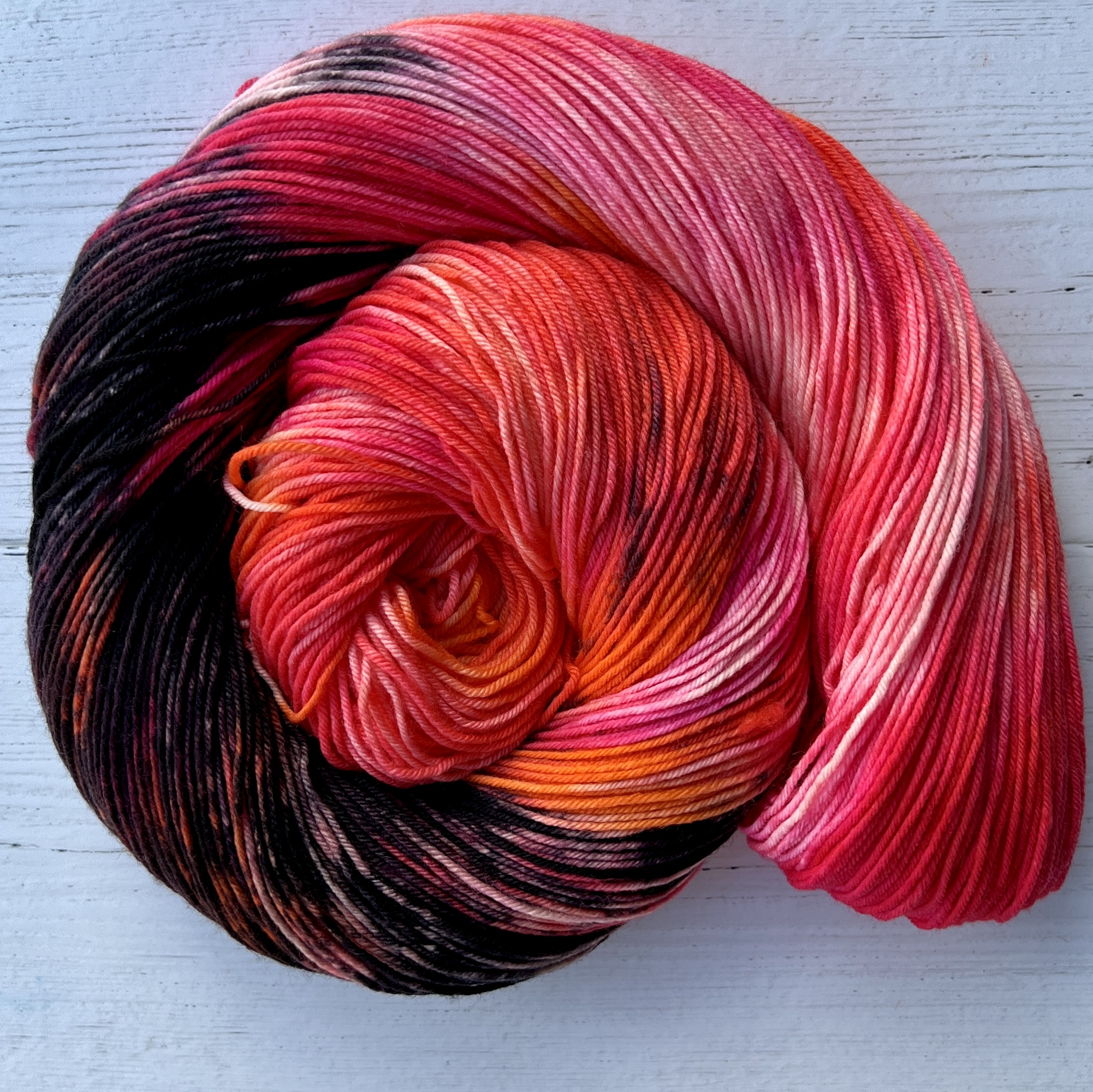 a skein of red, pink, black yarn